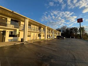 an empty parking lot in front of a building at Stay Inn in Kannapolis