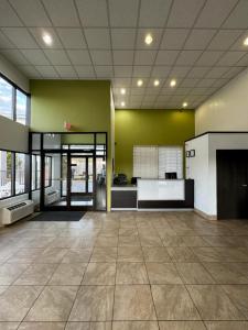 a large kitchen with green walls and a tile floor at Stay Inn in Kannapolis