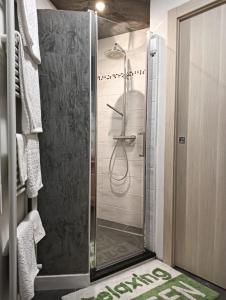 a shower with a glass door in a bathroom at Freddie house in Albiano