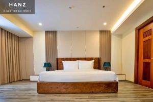 a bedroom with a large bed with white sheets at HANZ Premium Mai Vy Hotel in Tây Ninh