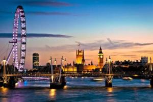 a bridge over a river with a city and a clock tower at APlaceToStay Central London Apartment, Zone 1 BOND in London +9 photos