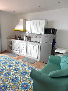 una cucina con frigorifero e un divano in camera di Sirenai Apartment a Colli di Fontanelle