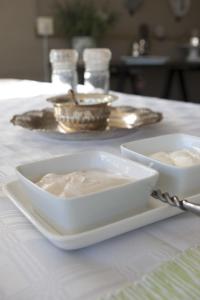 two bowls of dip sitting on a white table at Tancredi B&B in Pietermaritzburg