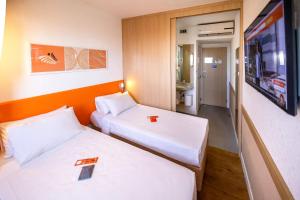 Postel nebo postele na pokoji v ubytování HUS Hotel MARINGA