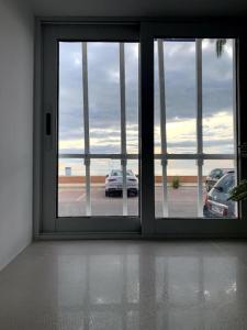 an open door with a view of a parking lot at Casita pescadores recién reformada frente al mar in Torrenostra