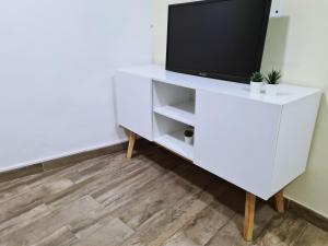 a white entertainment center with a television on it at MR House - Self Check-in in Coimbra