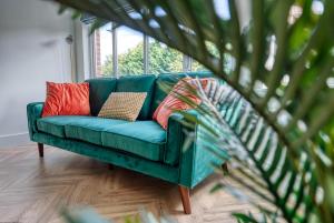 a green couch in a room with a window at Stylish 3 Bedroom Apartment in Southampton