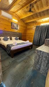 a bedroom with two beds in a wooden cabin at OZIBA BEACH RESORT in Arambol