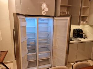 a refrigerator with its doors open in a kitchen at The Address Beach Resort Fujairah in Sharm