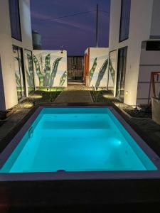 a swimming pool in front of a building at night at Che Lobitos in Lobitos