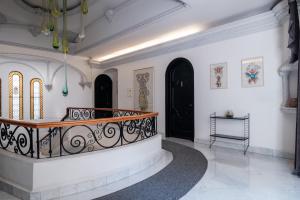 a hallway with white walls and black doors at Pug Seal Polanco Allan Poe in Mexico City
