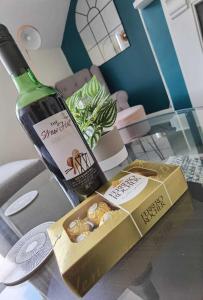 a bottle of wine and a box of snacks on a table at OPP Exeter RRF&T - Cosy 1 bed with parking BIG SAVINGS booking 7 nights or more! in Exeter