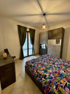 a bedroom with a bed and a dresser and window at il Nido sul lago Trasimeno in Castiglione del Lago