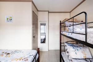 a bedroom with two bunk beds and a hallway at Lovely Nest Townhouse in Clark