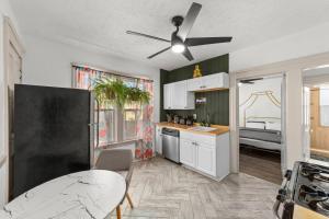 a kitchen with a table and a ceiling fan at Pet Friendly 2BR in Little Italy in Cleveland