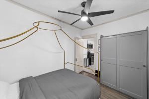 a bedroom with a bed and a ceiling fan at Pet Friendly 2BR in Little Italy in Cleveland