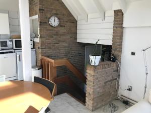 a kitchen and dining room with a brick fireplace at Globetrotter in Bergen