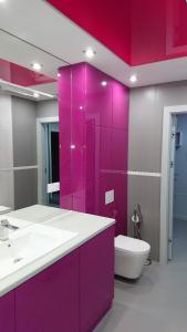 a purple bathroom with a toilet and a sink at Exclusive Kielce in Kielce