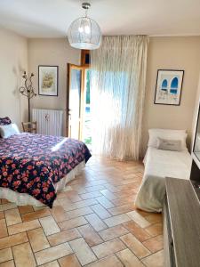 a bedroom with a bed and a tiled floor at Casa Isabelle in Canneto