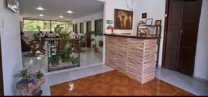 a lobby with a bar with potted plants in it at La Posada Casa Hostal in San Vicente de Chucurí