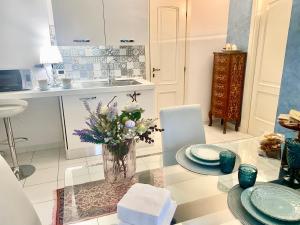 a kitchen with a vase of flowers on a glass table at CasAzzurra in Ortona