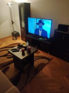 Una sala de estar con televisión y una mesa de café. en Całe mieszkanie 2 pokojowe na wyłączność centrum Częstochowy, bardzo blisko Jasnej Góry, 2 duże łóżka, en Częstochowa