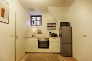 a kitchen with a refrigerator and a sink at Fewos zur Alten Brauerei - am Main Ochsenfurt - by homekeepers in Ochsenfurt