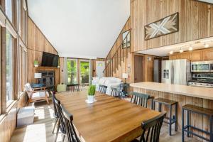 - une salle à manger et une cuisine avec une table et des chaises dans l'établissement Wooded family-size Chalet with Fire pit & Hot tub!, à Hedgesville