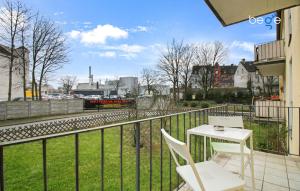 a balcony with a table and chairs and a train at BEGE APARTMENTS: FIRM RELAX in Mettmann
