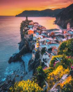 a group of buildings on a cliff near the water at Casa Vacanza Nonna Lida in Villafranca in Lunigiana