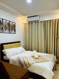 a bedroom with two beds and curtains in it at KENNA'S NOOK in Butuan