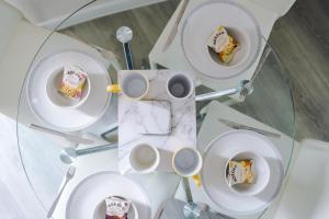 a table with plates of cake and cups of coffee at OPP Liverpool - Perfect for contractors and travellers, BIG SAVINGS booking 4 nights or more! in Liverpool