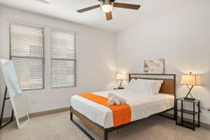 a bedroom with a bed and a ceiling fan at TWO Modern Waterfront CozySuites sidebyside in Tempe
