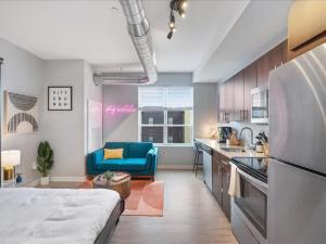 a kitchen with a blue couch in a room at CozySuites Boutique SDO, Lawrenceville in Pittsburgh