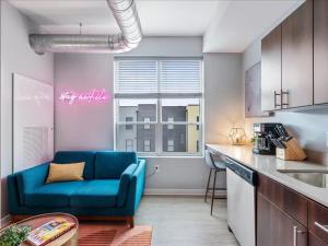 a living room with a blue couch in a kitchen at CozySuites Boutique SDO, Lawrenceville in Pittsburgh