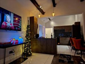 a living room with a christmas tree in a room at The Hamilton luxury holiday let's- Holly Barn in Scorton