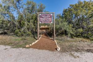 a sign for a trap cat sanctuary in a field at 12 Fires Luxury Glamping #3 in Johnson City
