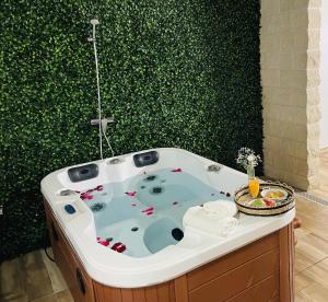 a jacuzzi tub in a bathroom with a green wall at La Palma Nature in Barlovento +25 photos