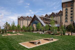 a park with two benches in front of a building at Gaylord Rockies Resort & Convention Center in Aurora