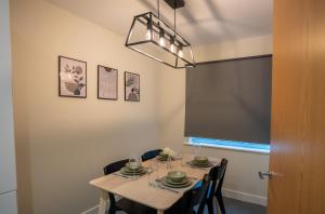 a dining room with a table and some chairs at Apple Tree in Redhill