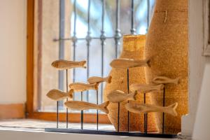 a group of wooden shoes on a stand next to a window at La Posada del Mar in Denia