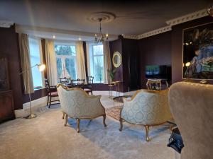a living room with two chairs and a table at Hamilton-The Alexander suite luxury holiday Let's in Scorton