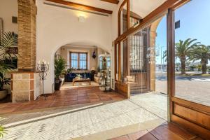 an open door of a house with a living room at La Posada del Mar in Denia