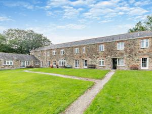 a large brick building with a large grass yard at 1 Bed in Perranporth THERO in Perranporth