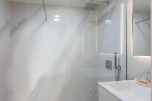 a white bathroom with a sink and a mirror at #11 Alex suite terrace parking AC 2 BDR 5mins to sea in Saint-Jean-Cap-Ferrat