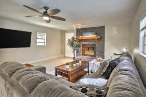 a living room with a couch and a fireplace at Backyard Oasis! 2 mi to Pier with Pool, Patio Bar & Putting Green in Safety Harbor