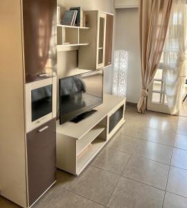 a entertainment center with a flat screen tv and a tv stand at Tenerife Paradise Anna Studio in Adeje