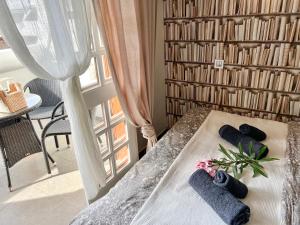 a bedroom with a bed with towels and a window at Tenerife Paradise Anna Studio in Adeje