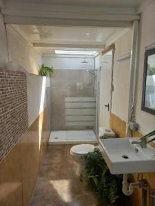 a small bathroom with a toilet and a sink at Sunset house in Soo