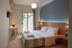 Postel nebo postele na pokoji v ubytování Oliv Apartments + 33 fotografií
